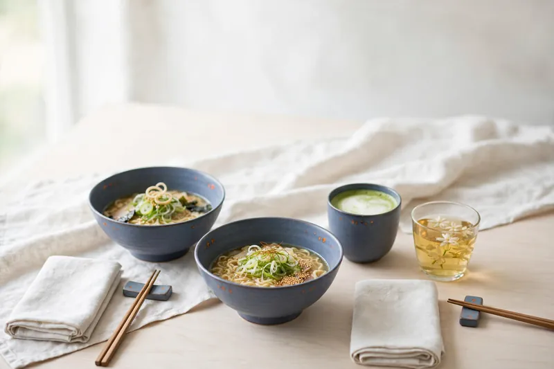 A table set for two with ramen and tea (illustration)